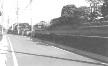 道路沿いに瓦のひさしがついた塀がたてられている伊勢街道の風景写真