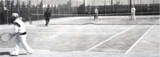 担い手センターのテニスコートでテニスをしている利用者の写真